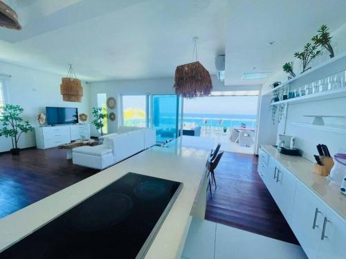 cocina y sala de estar con vistas al océano en Arenas Penthouse on the beach, en Sosúa