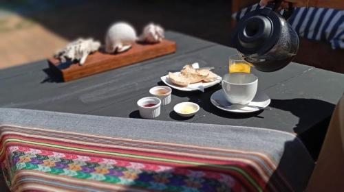 Hotel Casa Puccllana في كونستيتسيون: طاولة عليها إفطار من القهوة والطعام