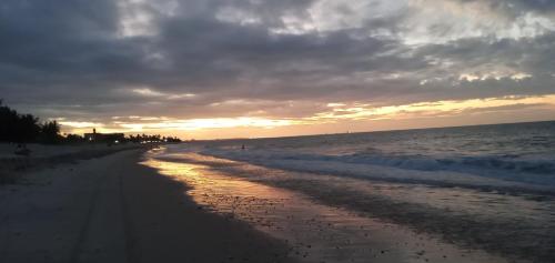 a beach with a cloudy sky and the ocean at Condomínio Beach Place Cumbuco. Ap: 206, Bloco 2 Paradise... in Caucaia