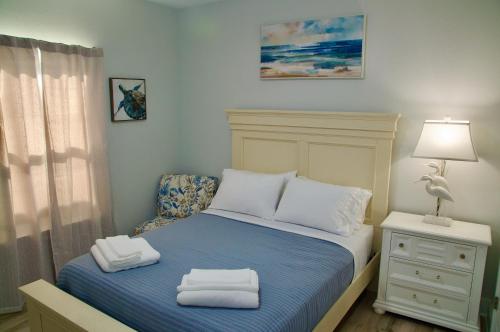 a small bedroom with a bed with towels on it at Peaceful Shores Retreat in Panama City Beach