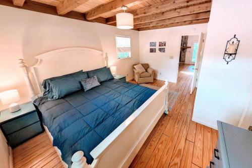 a bedroom with a large bed with a blue comforter at Hester Gap - wineries, AT hiking + Dahlonega/Helen in Cleveland