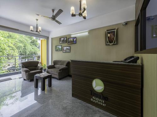 a lobby with a reception desk and a living room at Treebo Trend Akshaya Mayflower Vijaya Bank Layout in Bangalore