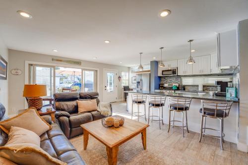 a living room with a couch and a table at Stunning Beach Home - large patio, parking, ac & dog friendly! in San Diego