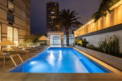 a swimming pool in a hotel at night at Holiday Inn Express - Antofagasta by IHG in Antofagasta