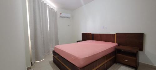 a bedroom with a bed with a pink mattress at PRIVÉ DAS THERMAS I apto 1001C in Caldas Novas