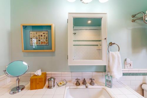 a bathroom with a sink and a mirror at Butterfly Landing in Pacific Grove