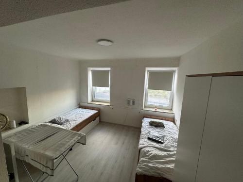 a room with two beds and a table in it at 1 Schlafzimmer Apartment in Euratsfeld