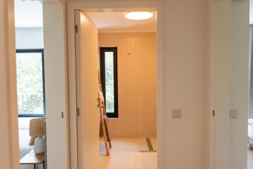 a hallway with a door leading into a bathroom at Quinta da Ribeirinha - Douro River in Paços de Gaiolo