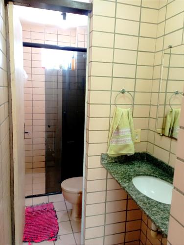 a bathroom with a sink and a toilet at Apto aconchegante in Cabedelo