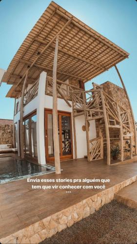 a building with a straw roof on top of it at Saona Bangalôs Taíba in Taíba