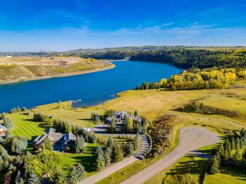 an aerial view of a lake and a house at Emerald Bay Luxury Retreat with Hot Tub in Calgary