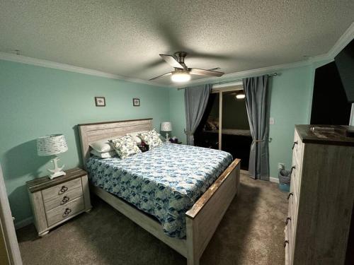 a bedroom with a bed and a ceiling fan at Barbara's Dream in Emerald Isle