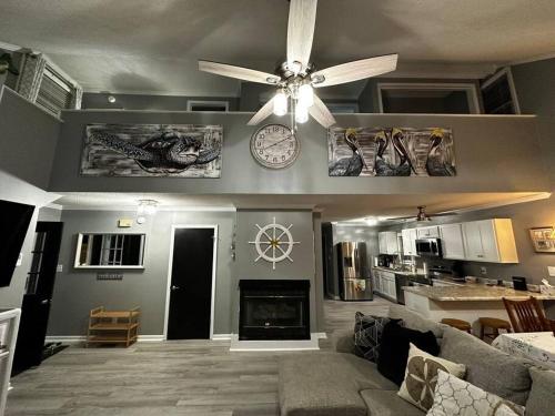 a living room with a ceiling fan and a fireplace at Barbara's Dream in Emerald Isle