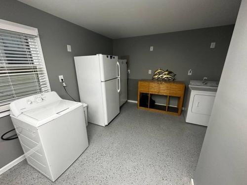 a kitchen with a refrigerator and a washer and dryer at Barbara's Dream in Emerald Isle