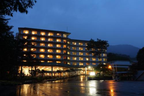 a hotel building with lights on at night at Tateyama Prince Hotel in Omachi