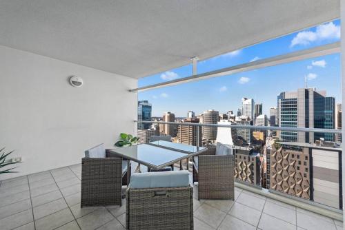 a balcony with a table and chairs and a view of the city at City Heights! 2Bed/1Bath/1Car/Views ~ CBD in Brisbane
