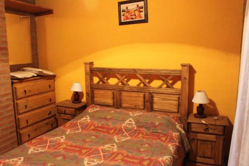 מיטה או מיטות בחדר ב-Cabañas Las Marias 1