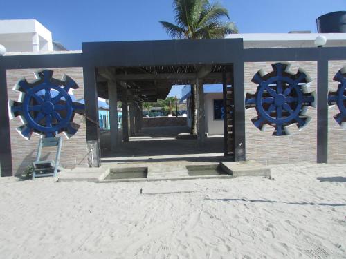 a building on the beach with two large blue decorations at LOS TIMONES in Coveñas