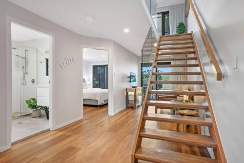 a staircase in a room with a bedroom at Sunrise Reef 6 in Lennox Head