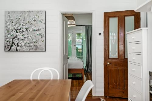 a dining room with a table and a painting on the wall at Swainson on Gordon in Port Adelaide