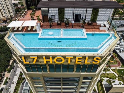 an overhead view of a swimming pool on top of a building at L7 WEST LAKE HANOI By LOTTE in Hanoi