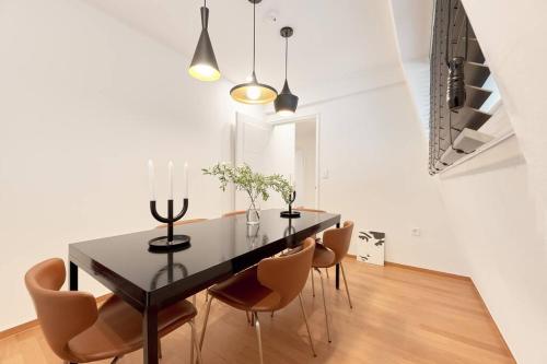 a dining room with a black table and chairs at Preesh house in Seoul