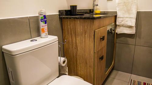 a bathroom with a white toilet and a sink at Container Lodge SB in San Bernardino