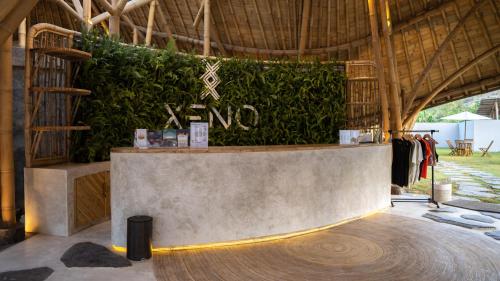 a store with a large green wall behind a counter at Kalea Villas in Kuta Lombok