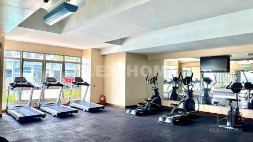 a gym with treadmills and cardio equipment in a room at 10am-6pm, SAME DAY CHECK IN AND CHECK OUT, Work From Home, Shaftsbury-Cyberjaya, Comfy Home by Flexihome-MY in Cyberjaya