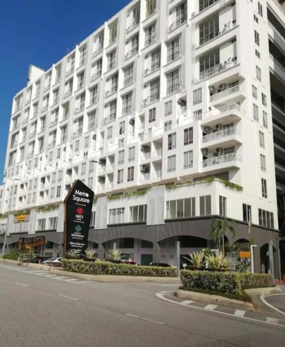 a large white building with a sign in front of it at Metra 308 Easy Suite in Ayer Keroh