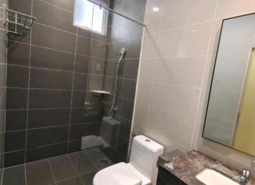 a bathroom with a shower and a toilet and a sink at Metra 308 Easy Suite in Ayer Keroh