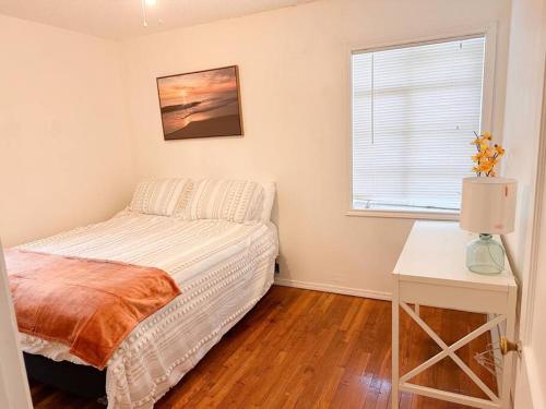 a bedroom with a bed and a table and a window at 3- hole putt-putt, fenced backyard in Lubbock