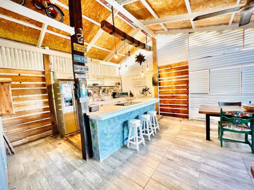 uma cozinha com um bar com um lavatório e um frigorífico em Nirvana Beach Home em Paraíso