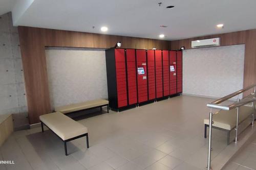 a waiting room with red lockers and a bench at Townhill Guesthouse @ Bandar Teknologi Kajang in Semenyih