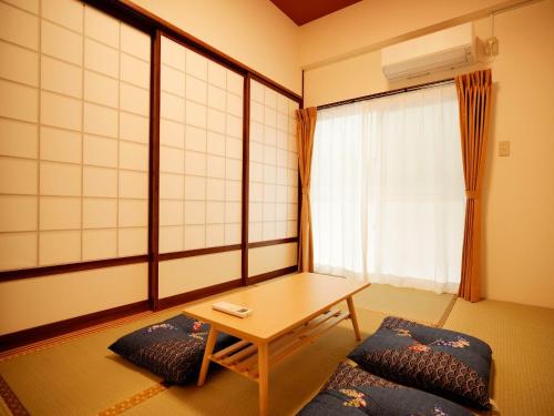 a room with a table and chairs and a window at Mcity in Maejima - Vacation STAY 54915v in Naha