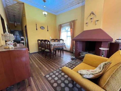 a living room with a couch and a dining room at Villa Paquita - Arco de Bellavista in Riobamba