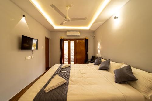 a bedroom with a large bed in a room at Lax Residency, White Town, Pondicherry in Puducherry
