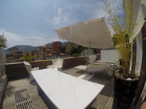 a balcony with a table and chairs and an umbrella at Casa Palmira in La Spezia