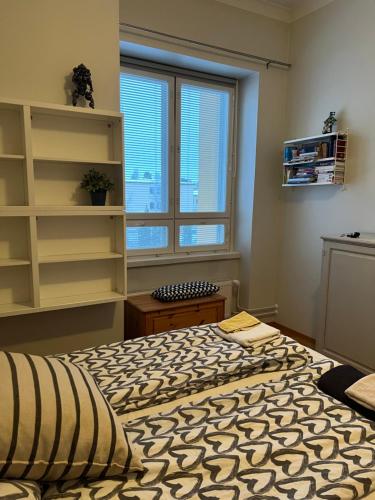 a bedroom with a large bed and a window at Saunallinen kaksio keskustassa in Kokkola