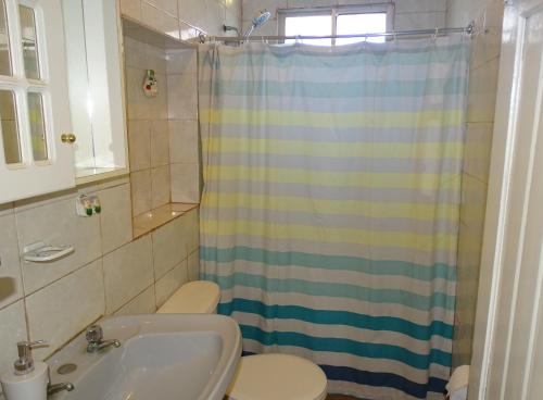 a bathroom with a sink and a toilet and a shower at Las Cruces in Las Cruces