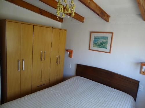 a bedroom with a bed with wooden cabinets and a chandelier at Las Cruces in Las Cruces