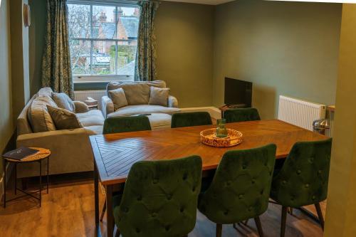 a living room with a table and a couch at The Castle City Centre Apartment in Canterbury