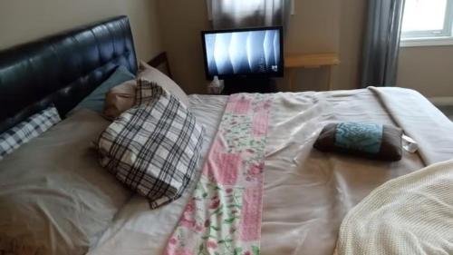 a baby laying on top of a bed at Waterloo Master bedroom with attached bathroom in Waterloo