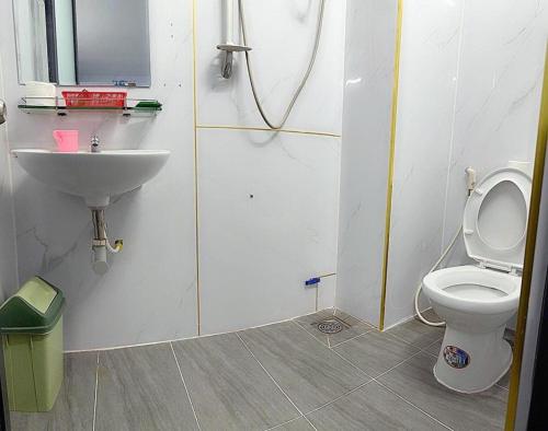 a bathroom with a toilet and a sink at Thiên Phước Hotel - 2/2/6a Thiên Phước- by Bay Luxury in Ho Chi Minh City