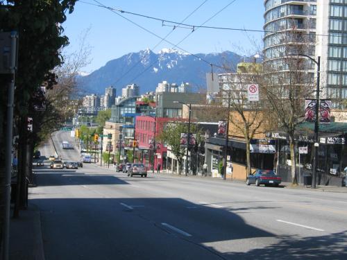 an empty city street with a mountain in the background at Charming Heritage Home with Mountain and City Views in Vancouver