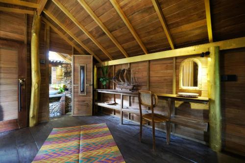a wooden room with a desk and a chair at Bara Beach Home in Galle