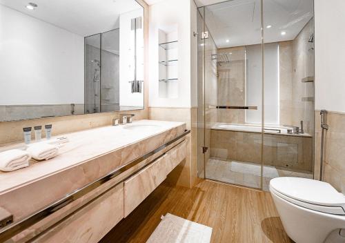 a bathroom with a sink and a toilet and a shower at 5-Star Studio at The Address Marina, Mall Access in Dubai