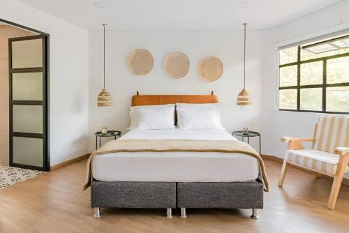 a bedroom with a bed and two mirrors on the wall at 574 Hotel in Medellín