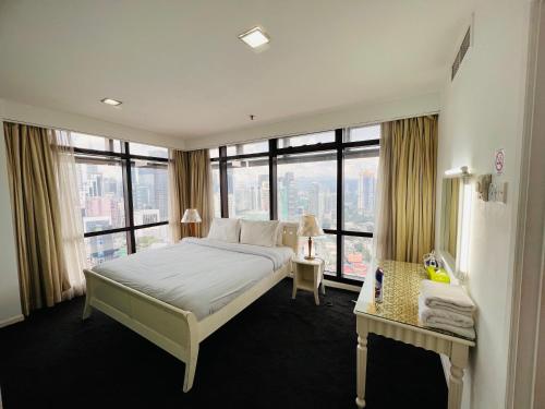 a bedroom with a large bed with a large window at Regal Residences At Berjaya Times Square in Kuala Lumpur