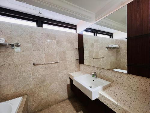 a bathroom with a sink and a mirror at Regal Residences At Berjaya Times Square in Kuala Lumpur